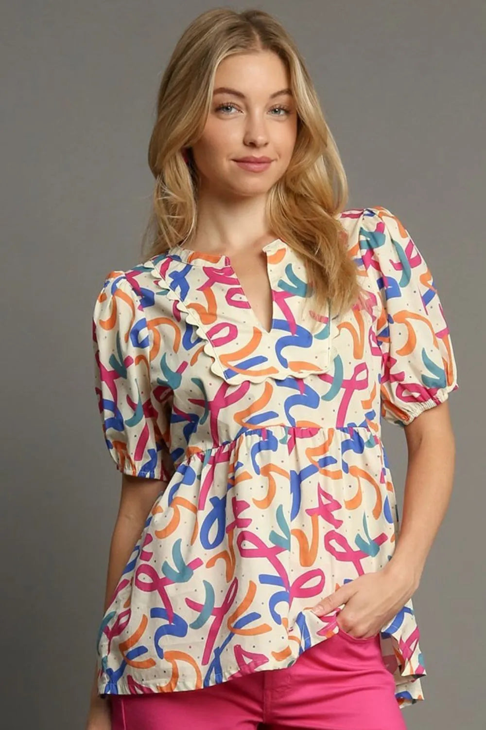 Plus size Umgee puff sleeve babydoll blouse with mixed print, featuring a flowy fit and feminine design.
