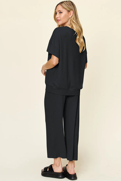 Trendsi Double Take full size textured round neck short sleeve T-shirt with wide-leg pants, casual outfit on a model.