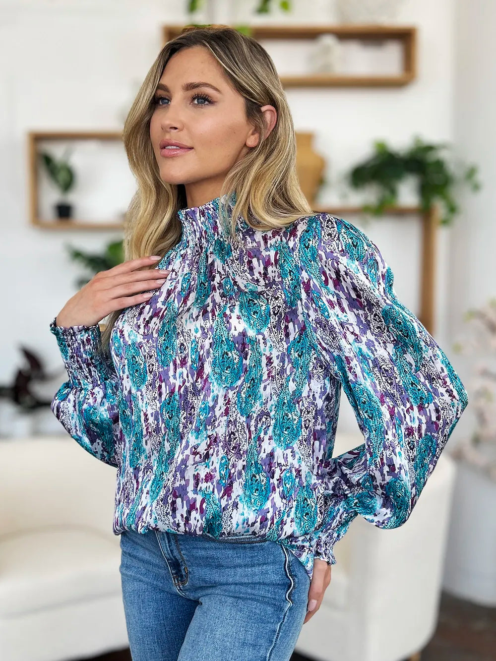 Printed smocked long sleeve blouse by Trendsi, featuring a full-size design with a stylish, gathered neckline and intricate print details.