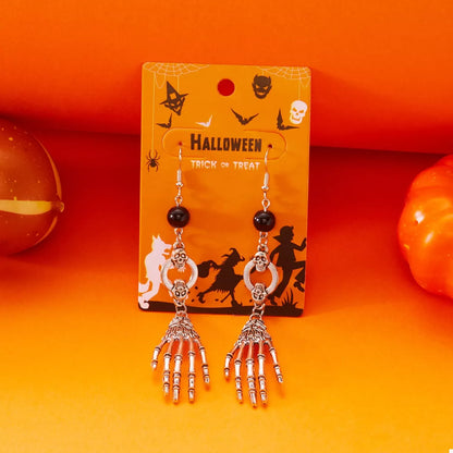 Skeleton hand drop earrings from Trendsi featuring spooky Halloween-themed design with detailed bone accents.