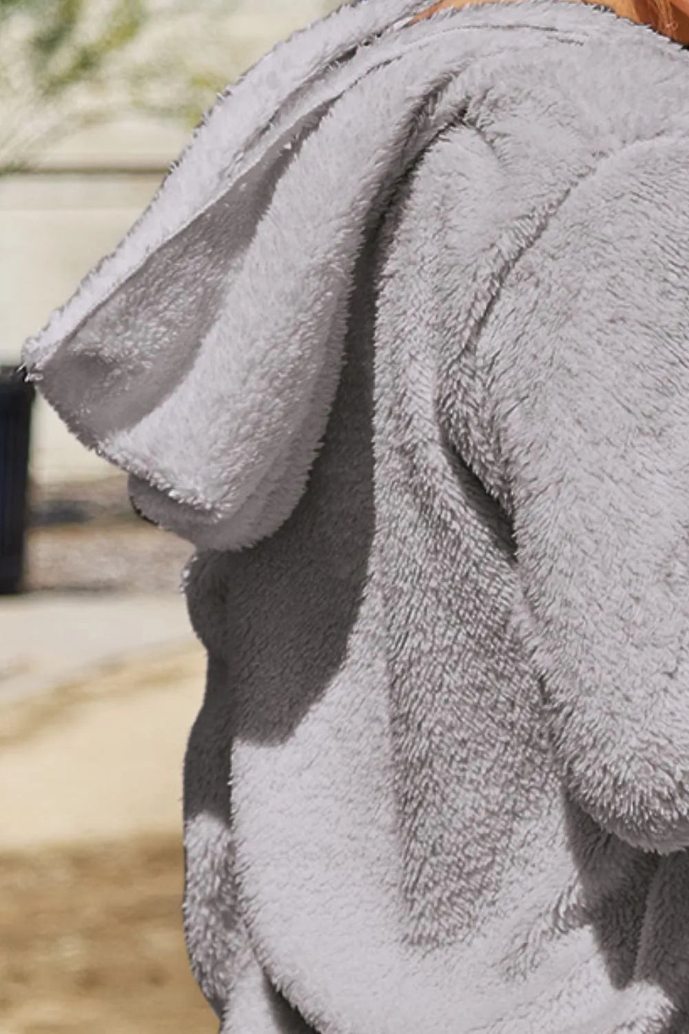 Full size Teddy hooded jacket with pockets, cozy and plush, by Trendsi, featuring a soft, furry texture and a comfortable hood.