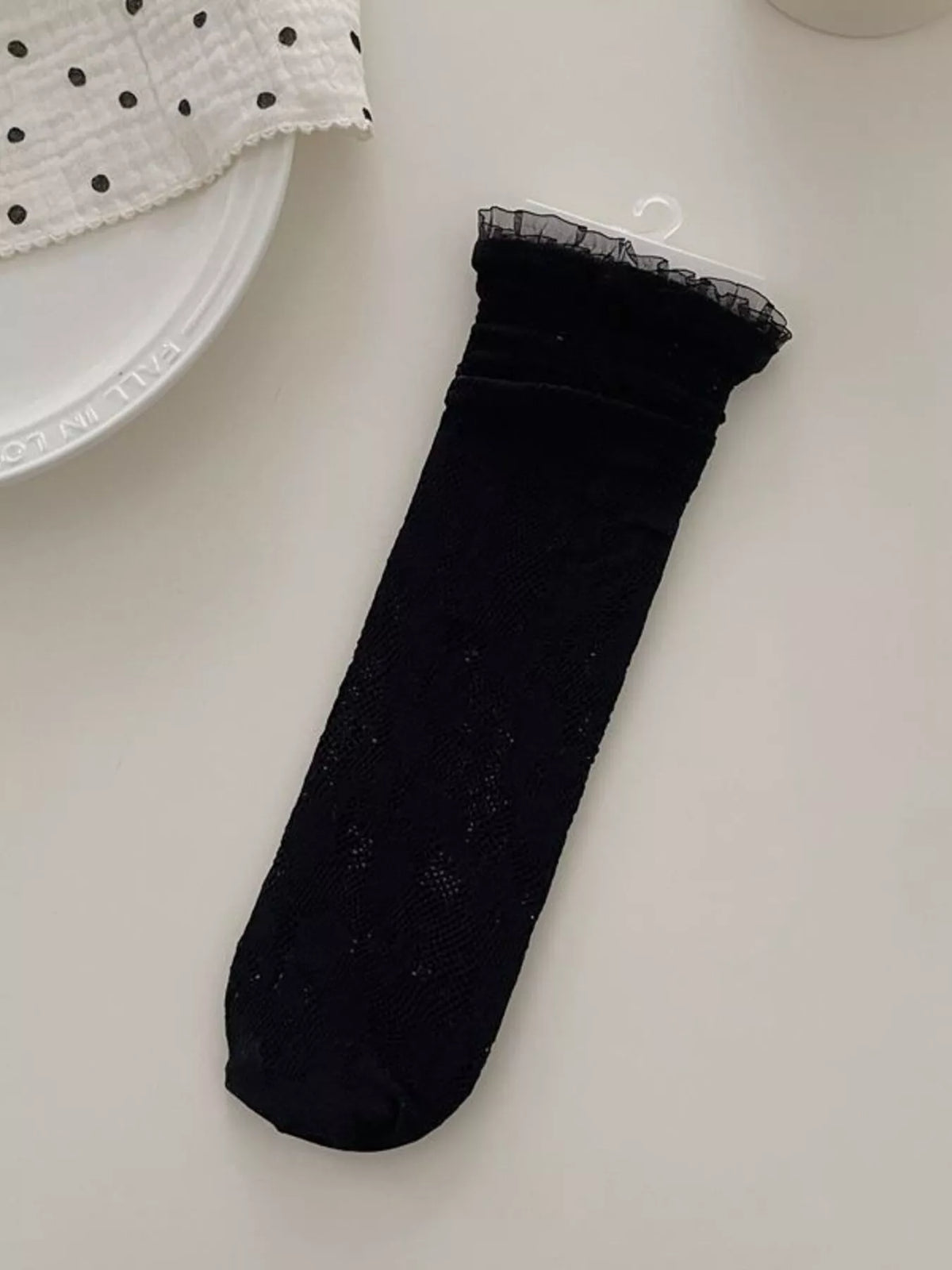 Lace fishnet mid-calf socks from Trendsi featuring intricate lace design and stretchable fishnet fabric for fashionable wear.