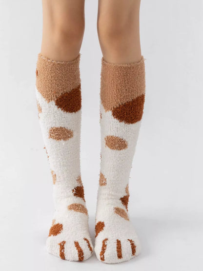 Fuzzy knee-high animal paw socks in soft fabric with paw print design, perfect for cozy, fun footwear styles.