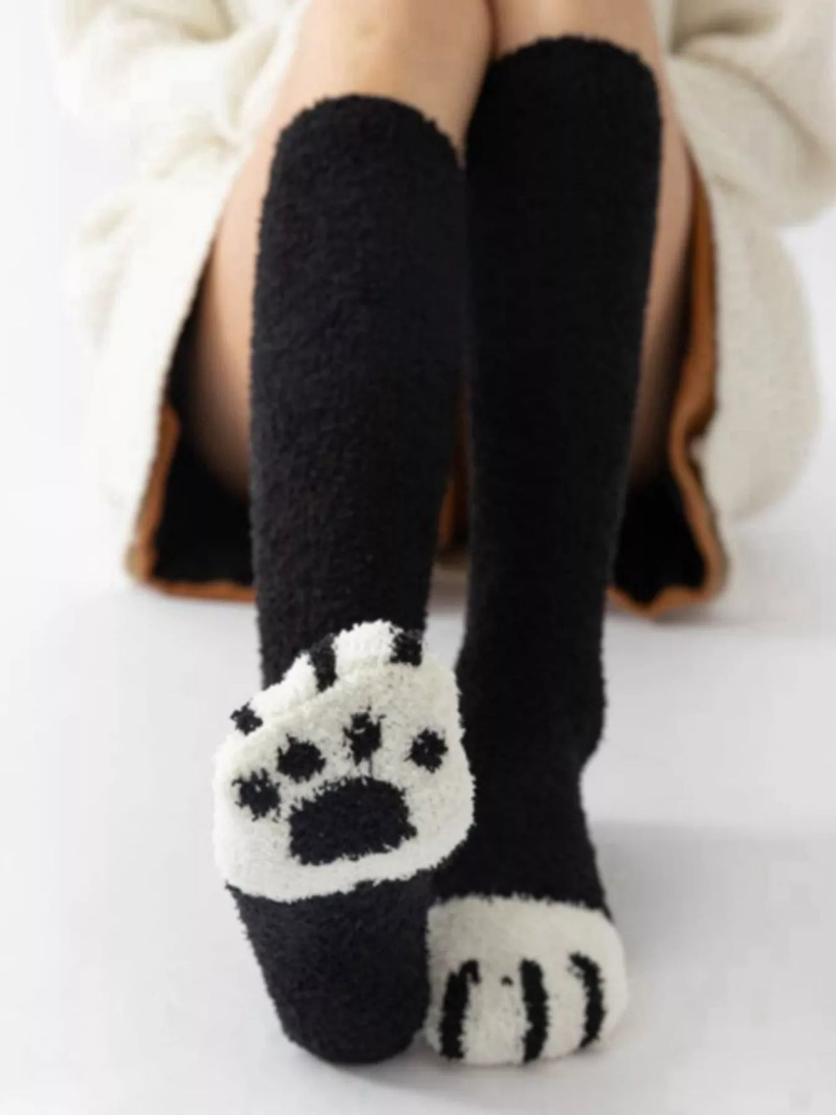 Fuzzy knee-high animal paw socks from Trendsi featuring soft, plush fabric and playful paw print design for cozy comfort.