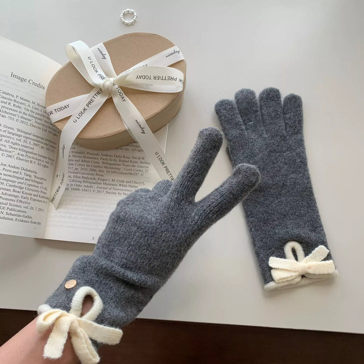Knit gloves with bow decoration, Trendsi brand, featuring soft fabric and stylish design perfect for cold weather accessories.