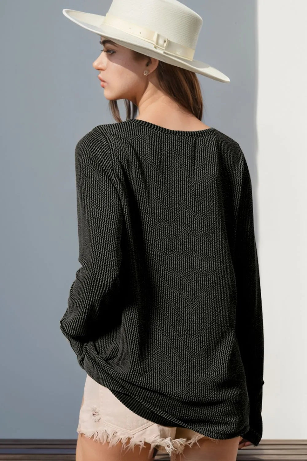 Long sleeve T-shirt with notched thumbholes, white color, and stylish design by Trendsi, perfect for casual wear.