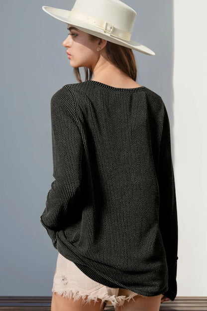 Long sleeve T-shirt with notched thumbholes, white color, and stylish design by Trendsi, perfect for casual wear.