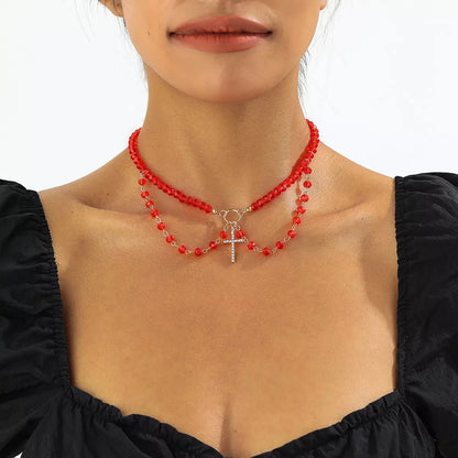 Halloween beaded cross pendant necklace with black and orange beads, featuring a silver cross charm, by Trendsi.