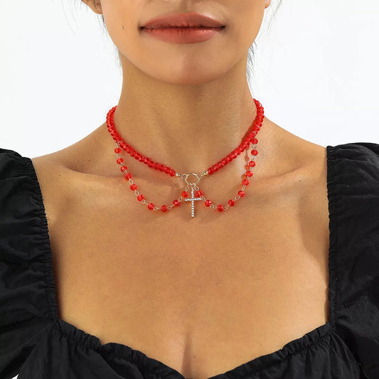 Halloween beaded cross pendant necklace with black and orange beads, featuring a silver cross charm, by Trendsi.