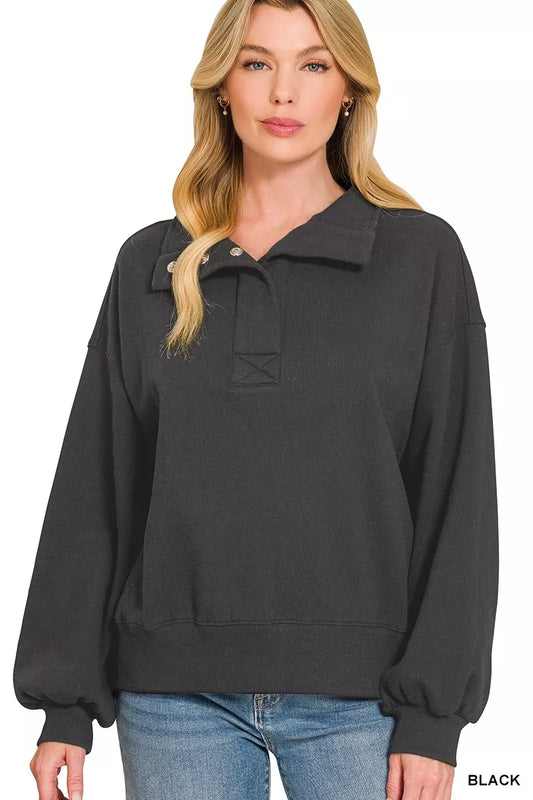 Black Zenana fleece half-snap button sweatshirt with a relaxed fit and cozy fleece material, displayed on a hanger.