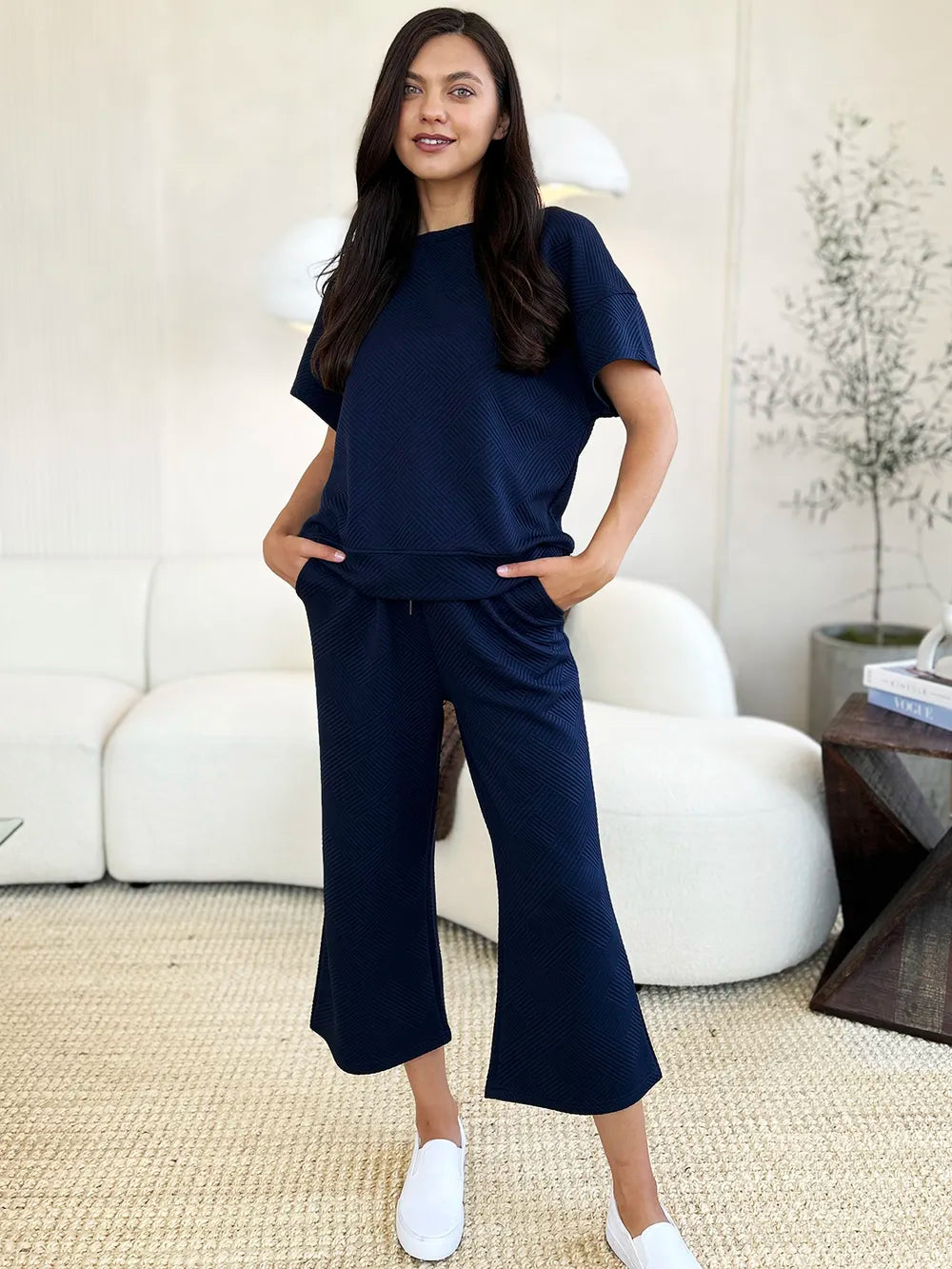 Double Take full size textured short sleeve top and pants set by Trendsi, featuring a stylish, coordinated matching outfit with a textured fabric.
