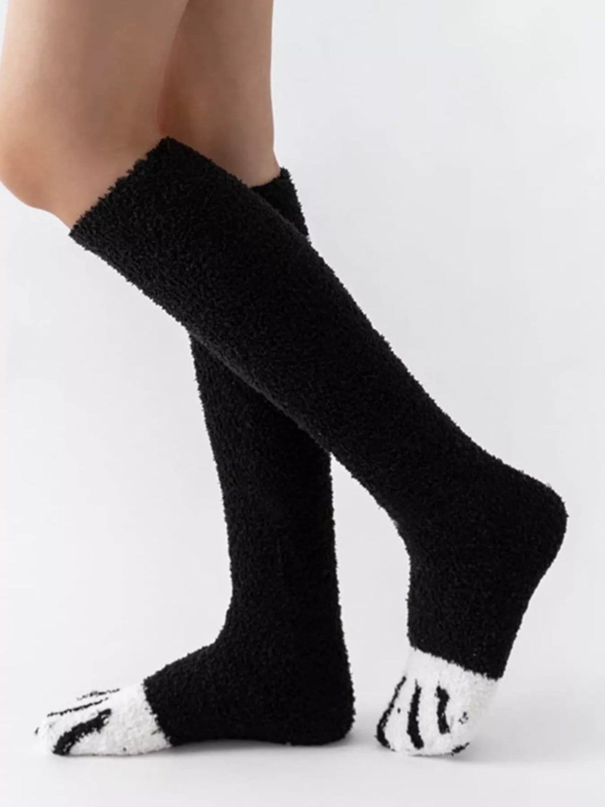 Fuzzy knee-high animal paw socks from Trendsi with soft, plush fabric and paw print design, ideal for cozy, stylish wear.