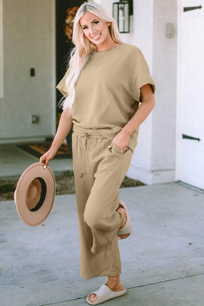 Trendsi Double Take textured short sleeve top and matching full-size pants set, stylish and comfortable for casual wear.
