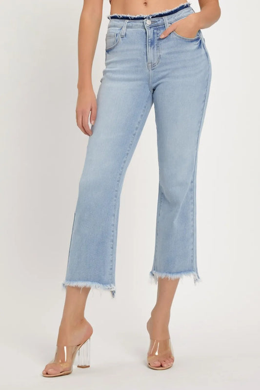 Risen high rise raw edge crop jeans in dark wash with distressed details, showing front view and frayed hem.