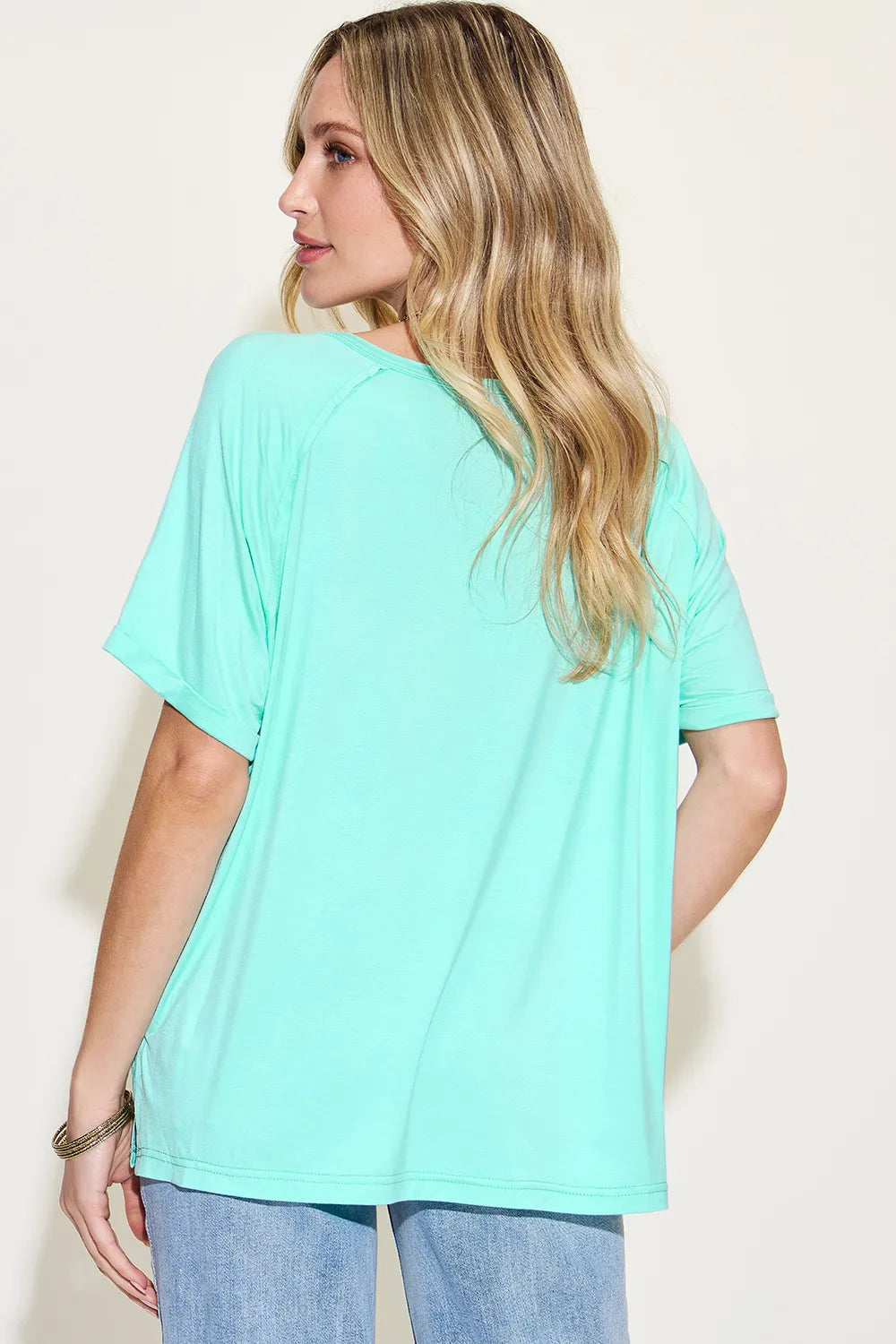 Basic Bae full size bamboo V-neck T-shirt from Trendsi, featuring short sleeves and a slit design in soft, sustainable fabric.