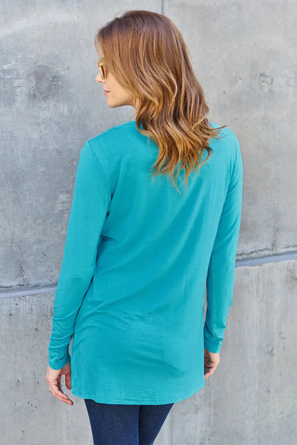 Basic Bae long sleeve round neck top by Trendsi, showing a close-up of the beige, full-size, casual women's long sleeve shirt.