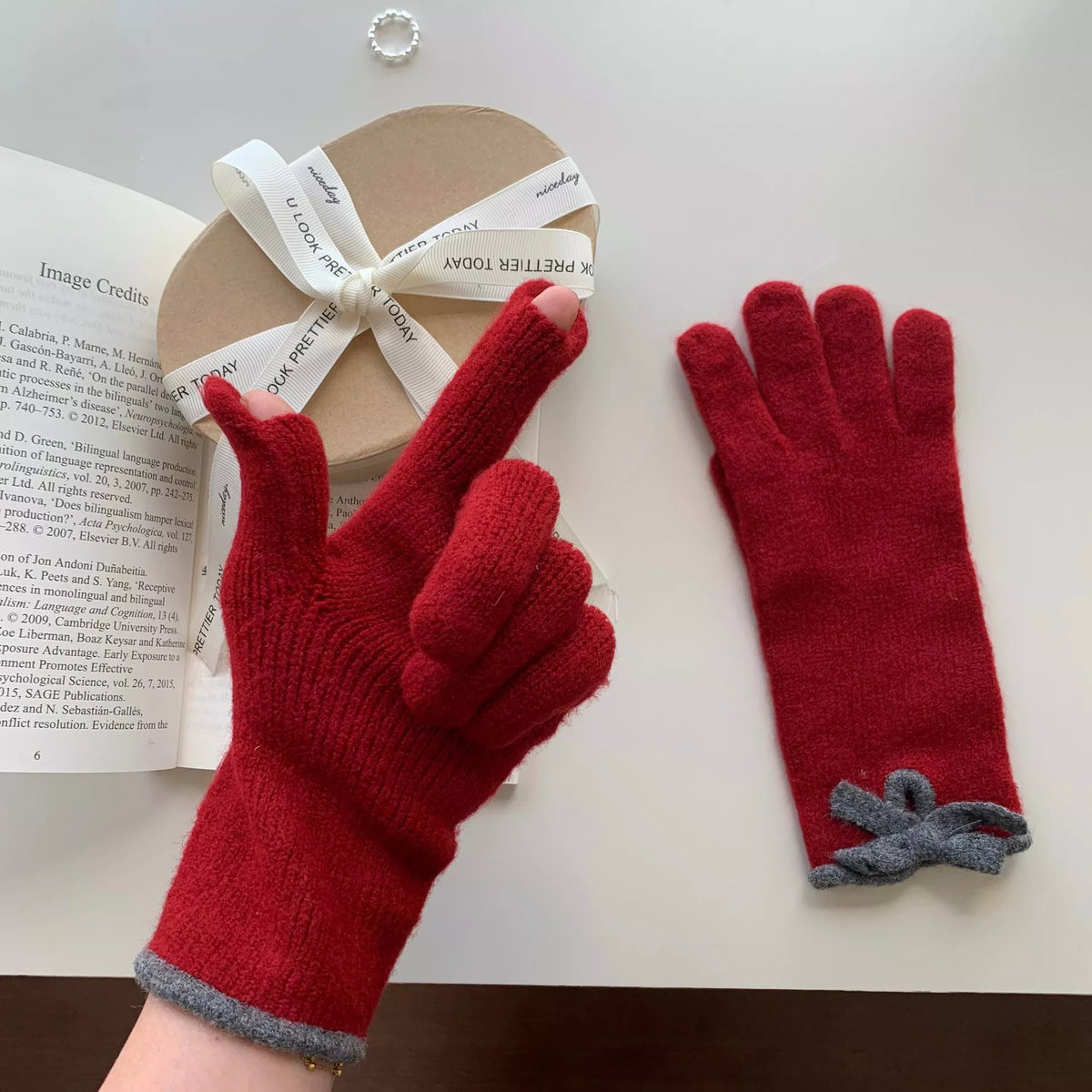 Knit gloves with bow decoration from Trendsi, featuring a cozy texture and stylish design for cold weather.