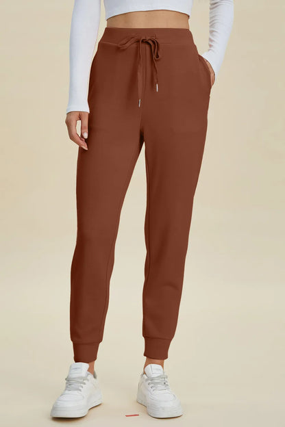 Trendsi Basic Bae full-size air scuba joggers with high waist, drawstring, and relaxed fit in black fabric.