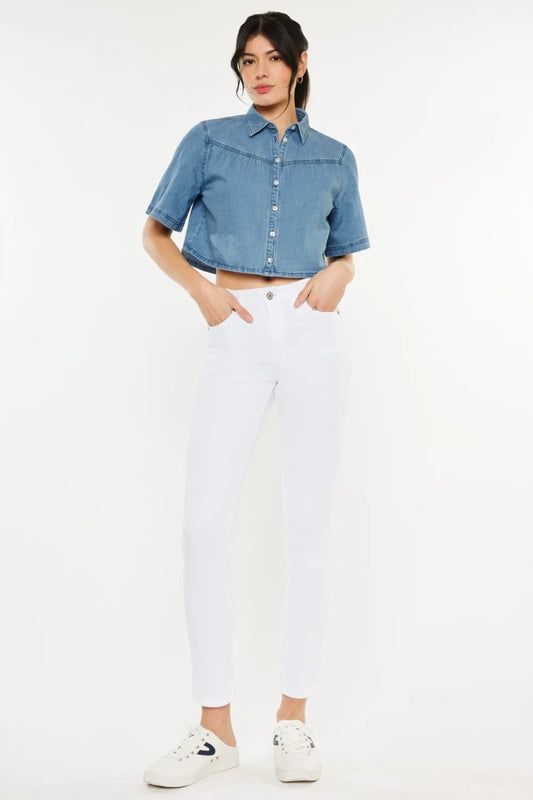 Kancan high rise ankle skinny jeans in dark wash, fitted style with front pockets and belt loops, displayed on a hanger.