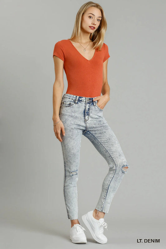 Trendsi Umgee distressed stretch denim skinny jeans with five pockets and unfinished hem, showcasing a fitted style and distressed details.