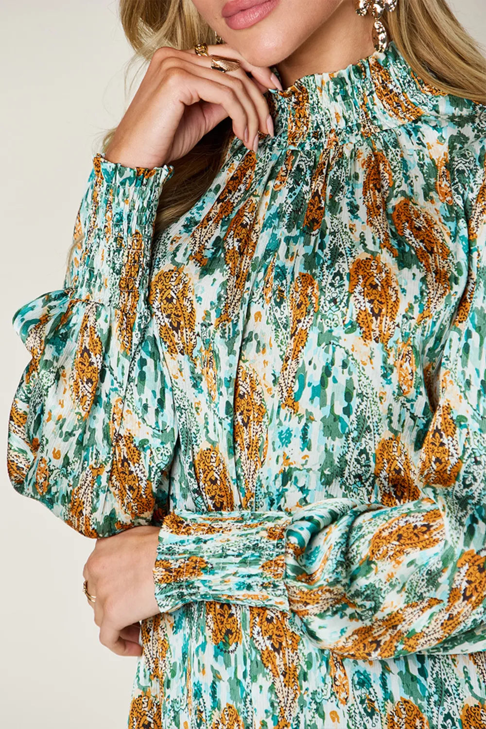 Printed smocked long sleeve blouse by Trendsi, featuring a full-size design with a stylish, gathered neckline and detailed fabric.