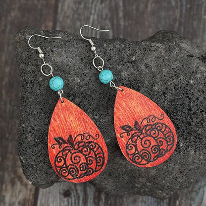 Turquoise wooden pumpkin teardrop earrings with carved details, stylish and lightweight jewelry accessory.