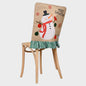 Festive MERRY CHRISTMAS chair cover by Trendsi featuring holiday-themed red fabric with white lettering on a dining chair.