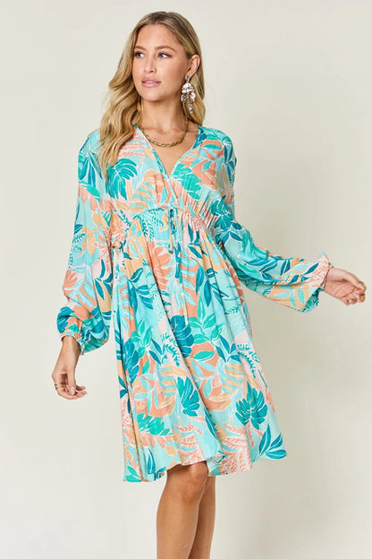 Printed V-neck drawstring dress by Trendsi featuring a double take full-size design with stylish pattern and comfortable fit.