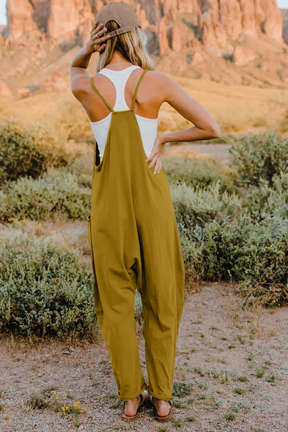 Trendsi Double Take full size sleeveless V-neck jumpsuit with pockets, shown in black fabric on a mannequin.