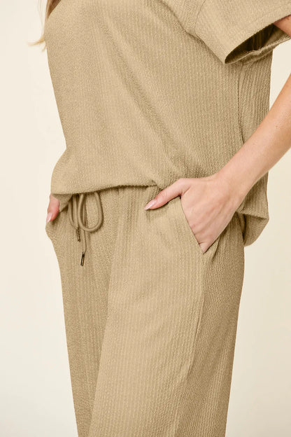 Trendsi double take full size textured round neck short sleeve t-shirt paired with wide-leg pants, casual stylish outfit.