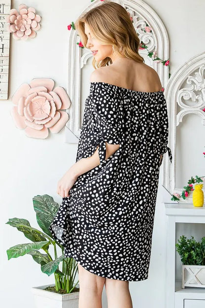 Heimish full-size short sleeve off-shoulder animal print mini dress by Trendsi, shown in plus size with a relaxed fit and stylish design.