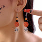 Halloween Spider Pumpkin Drop Earrings featuring black spider and orange pumpkin charms, perfect for festive fall accessorizing.