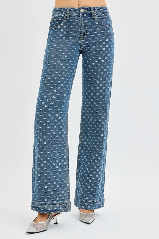 Risen high-rise wide-leg jeans with bow embroidery, trendy denim with embroidered details, styled for a casual chic look.