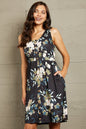 Printed sleeveless casual dress by Trendsi featuring front buttons, ruched waist, side slit, and pockets.