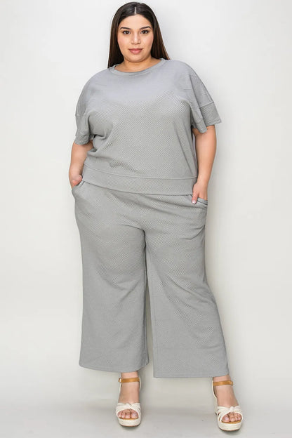 Trendsi Double Take full size textured short sleeve top and matching pants set, stylish casual outfit with a comfortable fit.