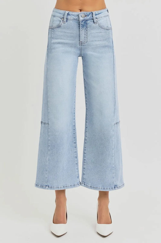 Risen high-rise wide-leg crop jeans with seamed details in denim, showcasing the fitted waist and relaxed leg fit.