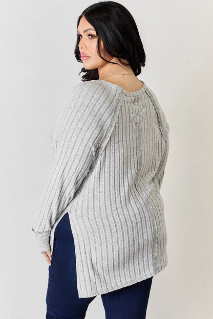 Basic Bae full size ribbed round neck slit T-shirt by Trendsi, featuring ribbed fabric and a stylish slit detail at the side.