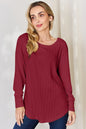 Basic Bae full-size ribbed round neck slit T-shirt by Trendsi, featuring a comfortable ribbed fabric and stylish slit detail.