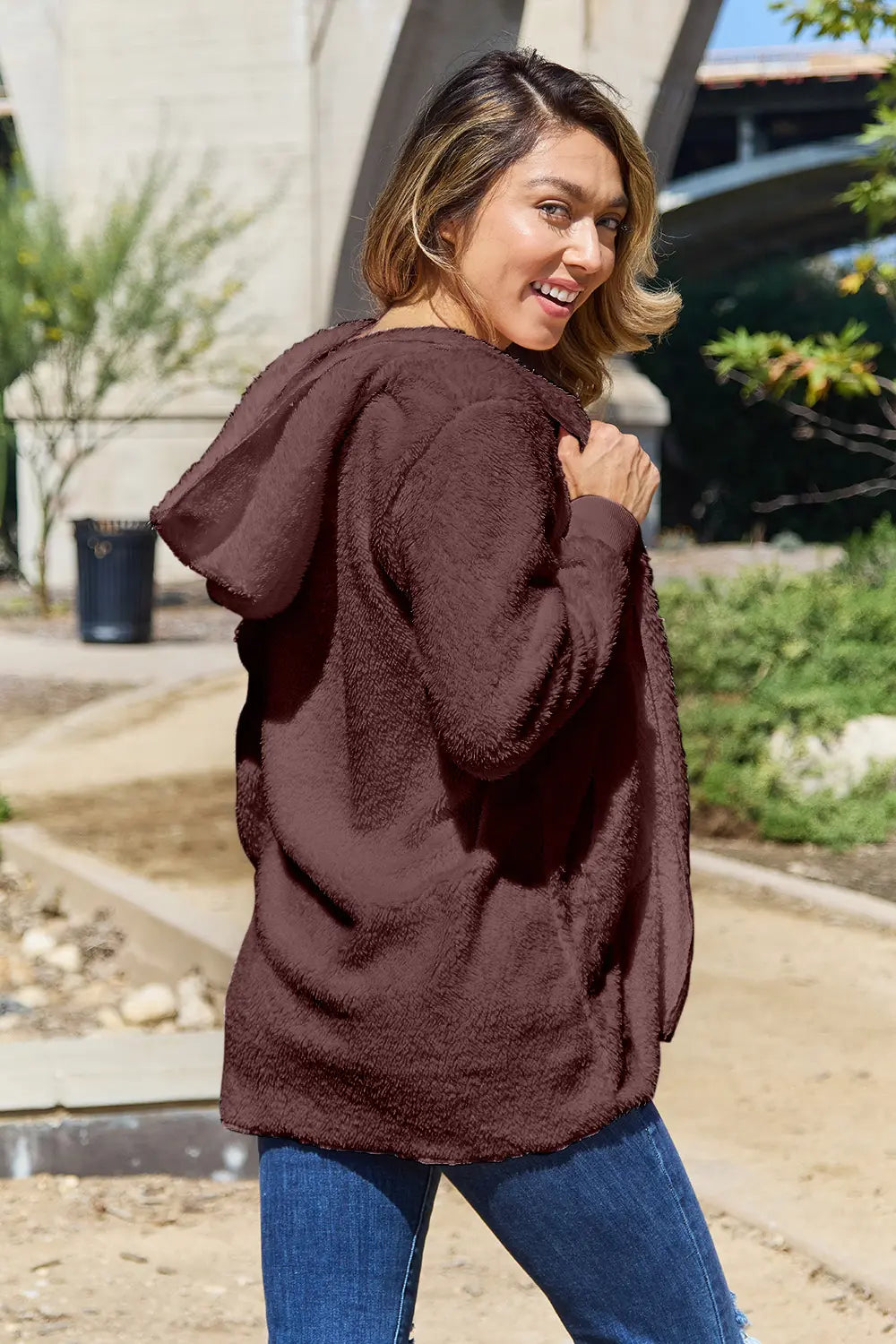 Full size Teddy Hooded Jacket with Pockets by Trendsi showing soft, plush fabric, hood, and front pockets on a model.