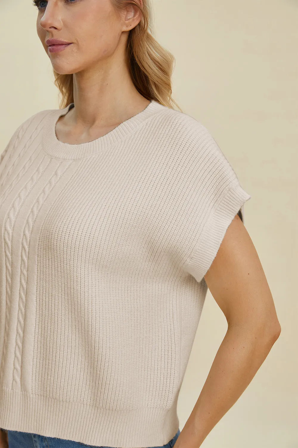 Plus size cable-knit round neck short sleeve sweater by Trendsi, showing a cozy, full-size cable-knit sweater with a classic fit.