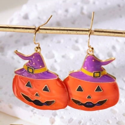 Halloween pumpkin dangle earrings by Trendsi featuring festive orange pumpkin charms hanging from silver hooks.