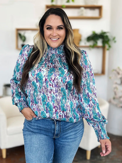Printed smocked long sleeve blouse from Trendsi, featuring a double take full size design with stylish details and a comfortable fit.