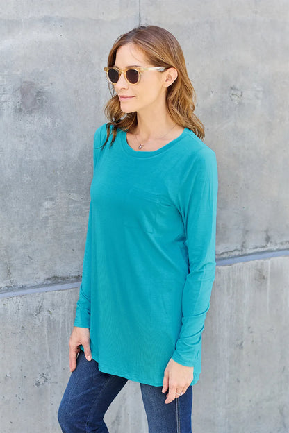 Basic Bae full size round neck long sleeve top by Trendsi, shown in black with a relaxed fit and simple design.