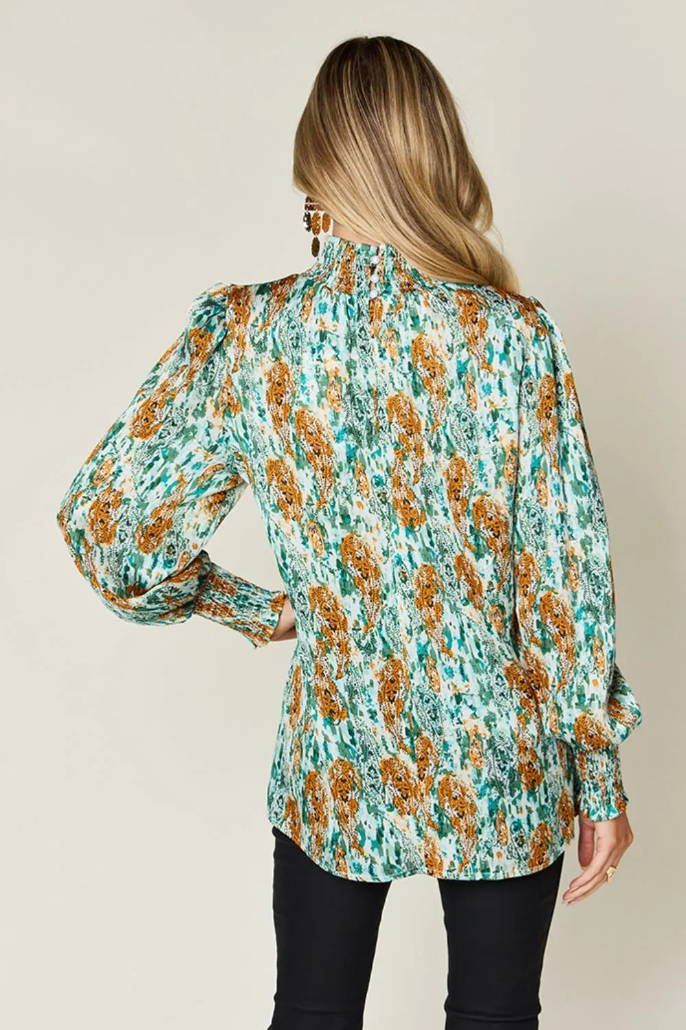 Printed smocked long sleeve blouse by Trendsi featuring a double take design and full size fit, with a stylish, feminine silhouette.