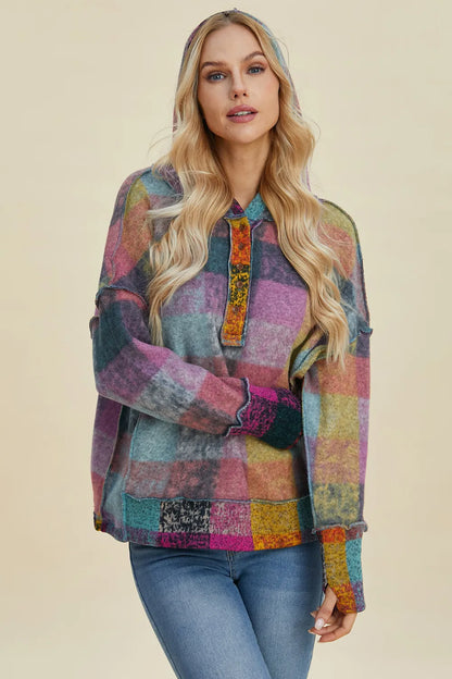 Plus size plaid fleece hoodie with dropped shoulders from Trendsi, featuring a cozy, oversized fit and stylish plaid pattern.
