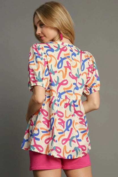 Plus size Umgee mixed print puff sleeve babydoll blouse, full size trendy women's top with feminine style and vibrant pattern.