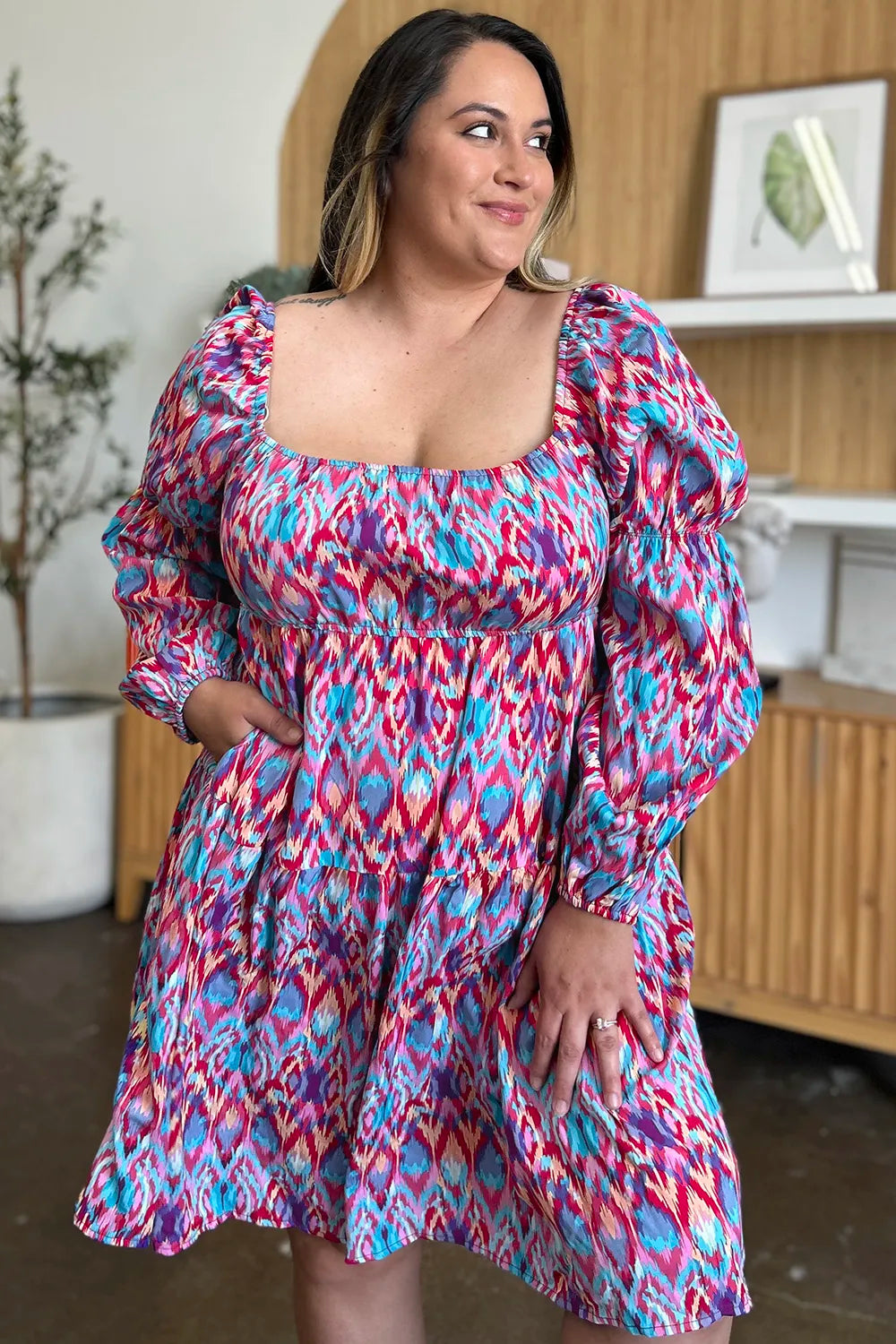 Long sleeve printed full-size dress by Trendsi, featuring a stylish design and comfortable fit.