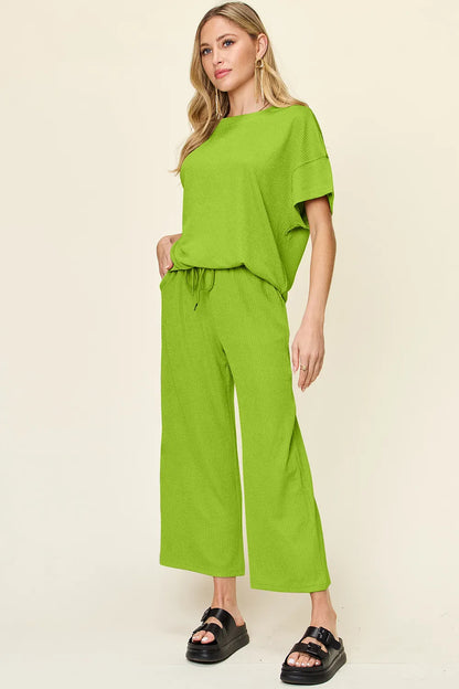 Trendsi Double Take full size texture round neck short sleeve T-shirt paired with wide-leg pants, displayed on a mannequin.