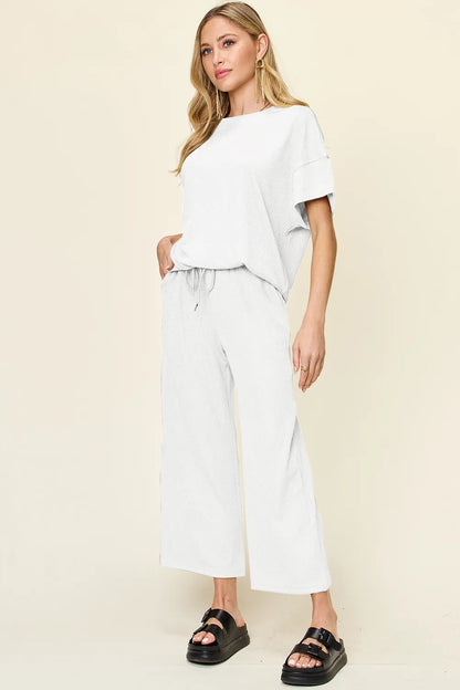 Trendsi Double Take full-size textured round neck short sleeve T-shirt with wide-leg pants, casual and comfortable outfit.