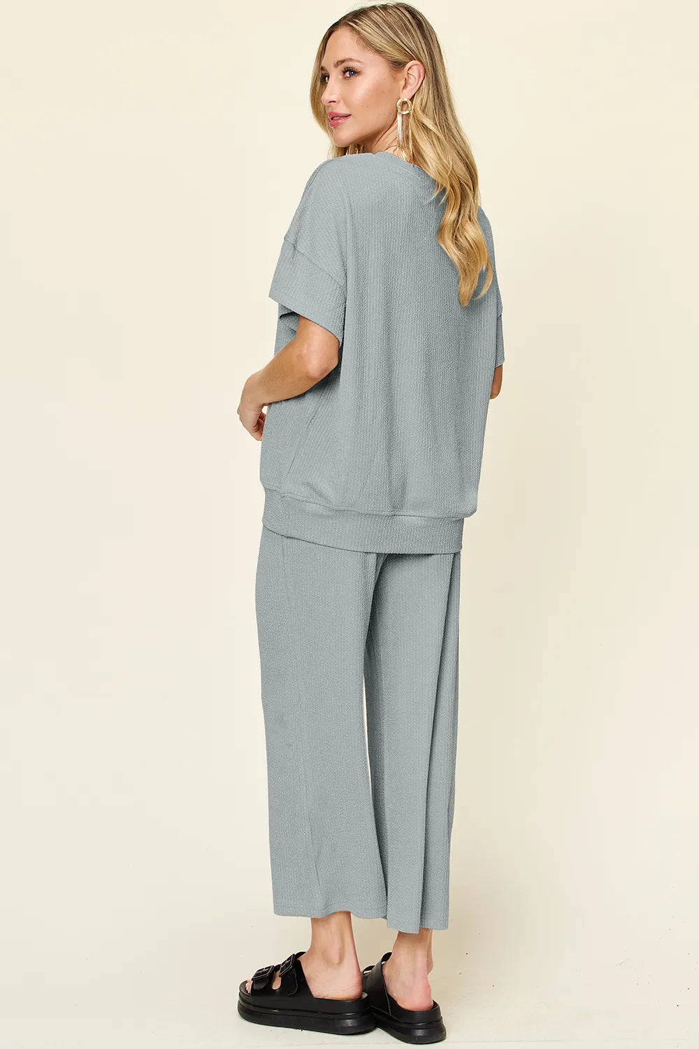 Trendsi double take full size textured round neck short sleeve T-shirt with wide-leg pants, showcasing casual stylish outfit.